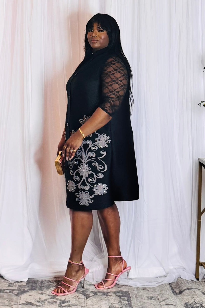 Close-up of floral hem embroidery on black stretch dress