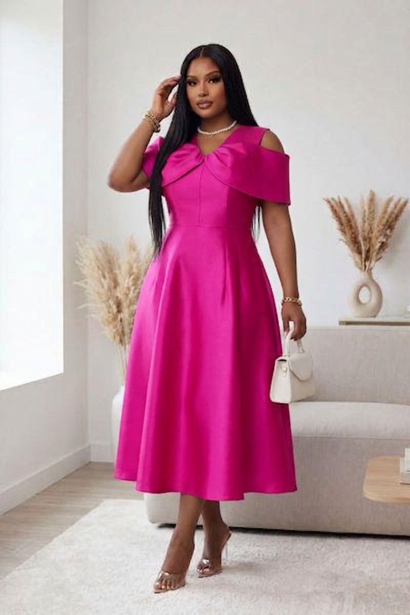Woman wearing a bright pink dress on a white background