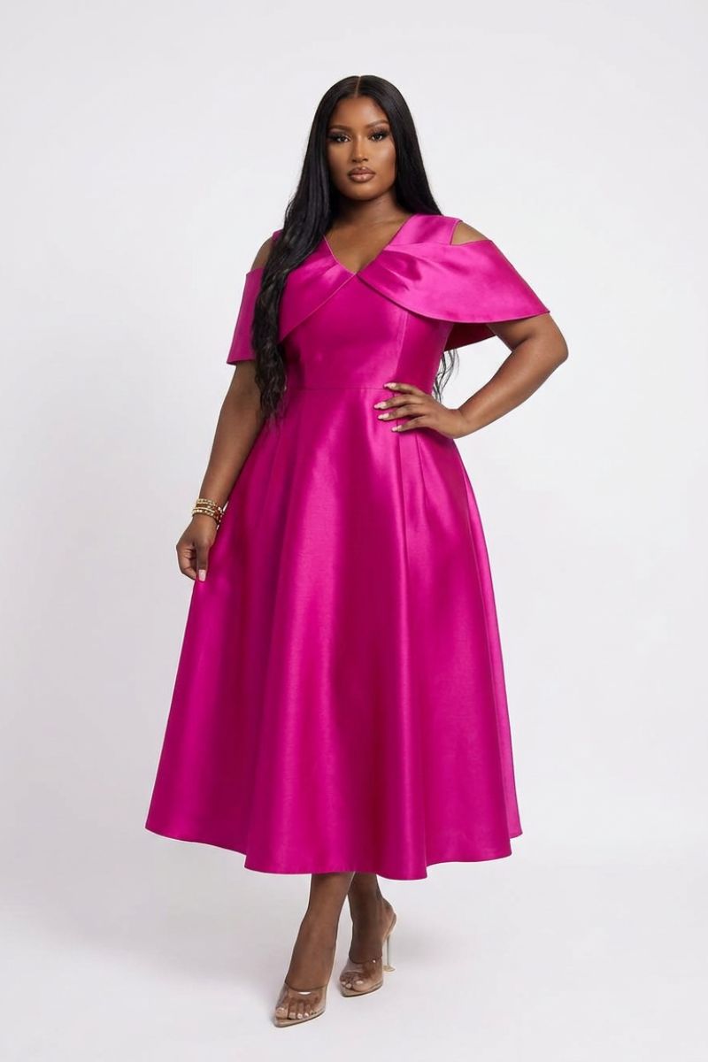 Woman wearing a bright pink dress on a white background