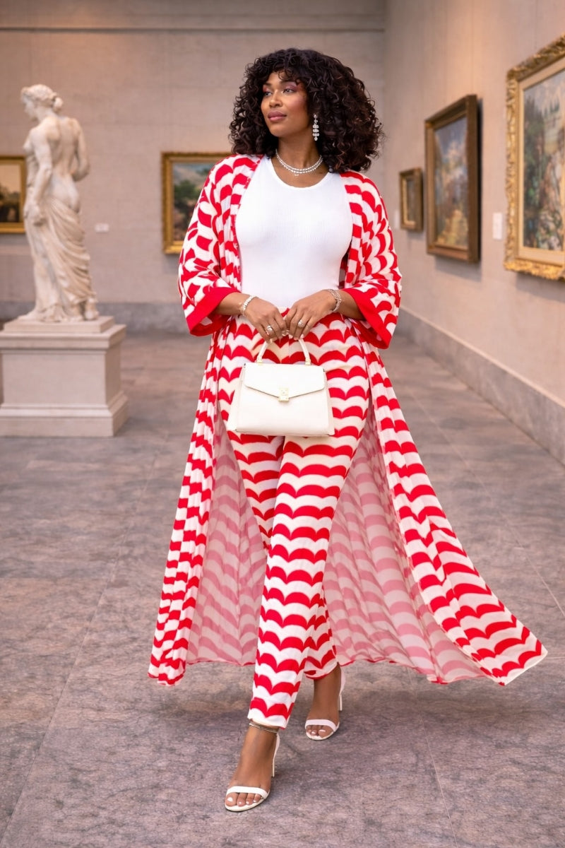 Woman in a red and white striped outfit standing in an art gallery.
