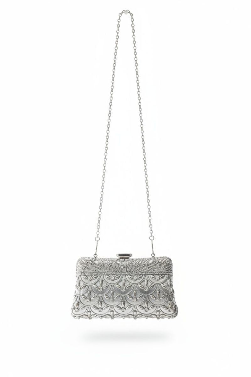 A silver metallic clutch bag with an intricate textured pattern and a matching silver chain strap, shown against a plain white background.