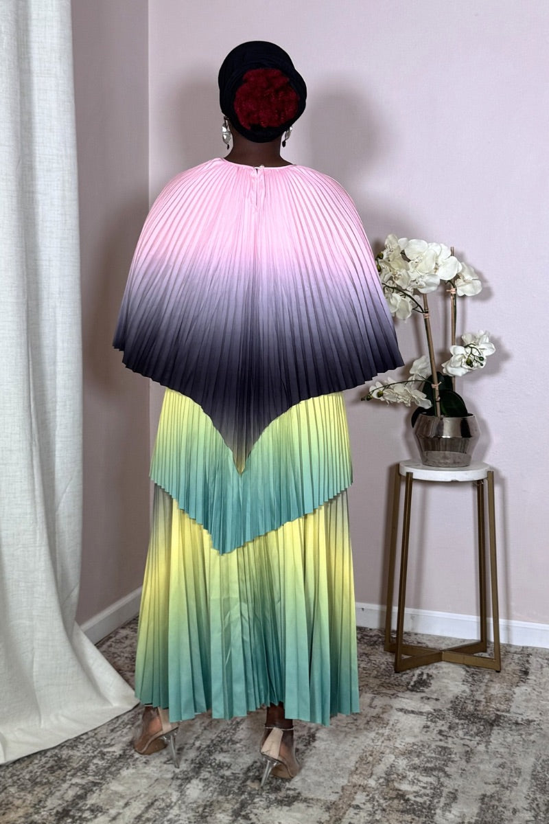 Full-length Aurora Meadow Bloom pleated set with cape top and flowing maxi skirt.