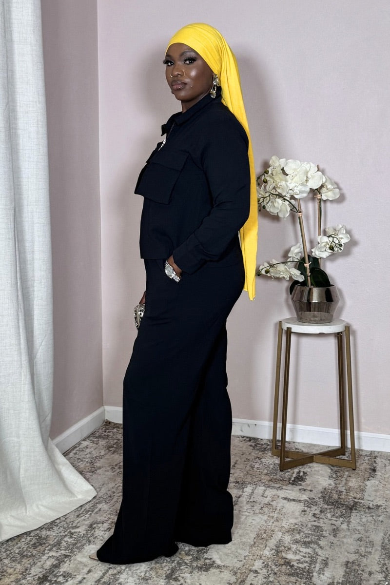 Side view of Black Utility Cropped Zip Set showing sculptural silhouette.
