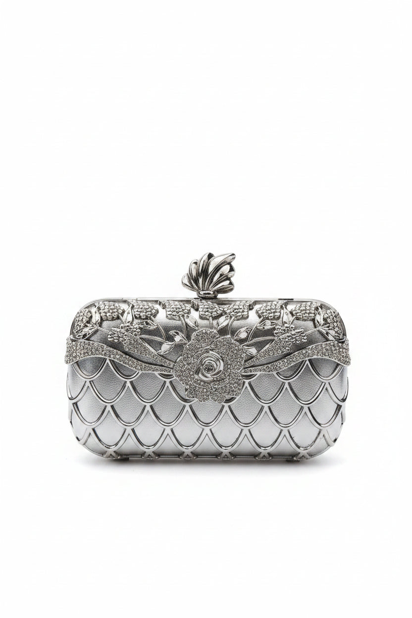 Decorative clutch bag with intricate design on a textured surface
