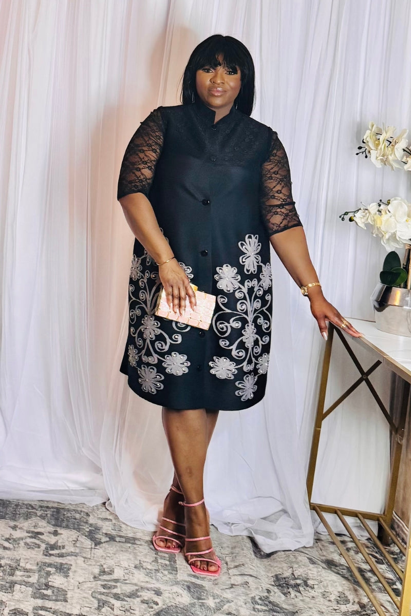 Model wearing one-size black floral embroidered dress with pink heels
