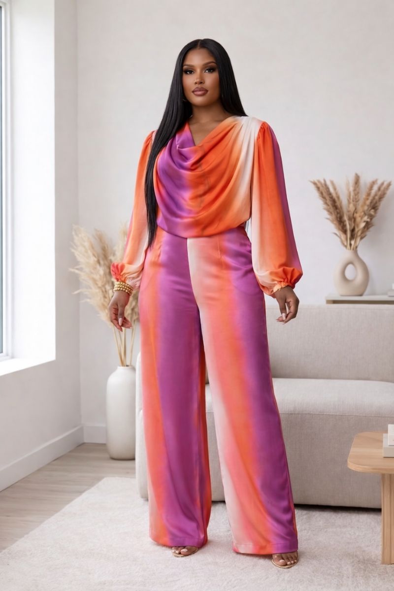 Model wearing Sunset Glow Satin Cowl-Neck Set in watercolor sunset print with coral, pink, orange, and lavender.